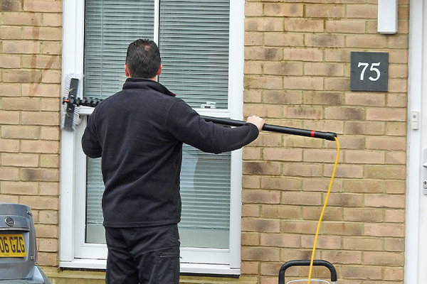 An image of a man cleaning windows